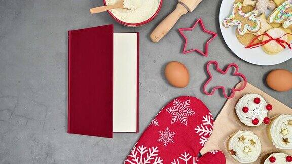 打开红色的书出现在桌子上的圣诞饼干和烘焙材料停止运动