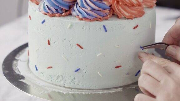 在圆形香草蛋糕的侧面撒上彩色的糖屑