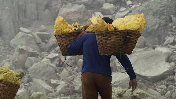 在卡瓦伊真火山搬运篮子的硫磺矿工
