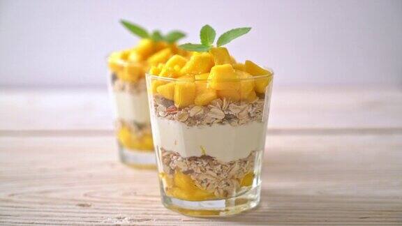 新鲜芒果酸奶与格兰诺拉麦片玻璃健康食品风格