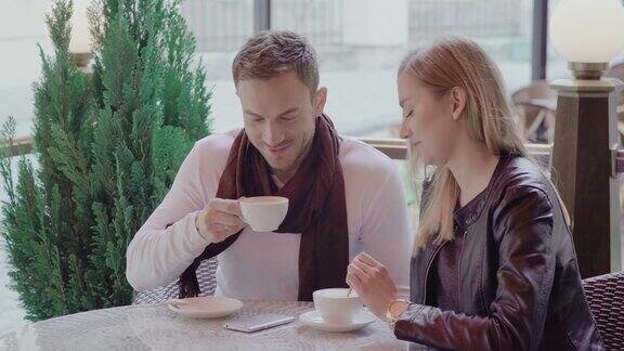 一对情侣在户外咖啡馆约会喝咖啡
