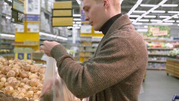 一个男人在超市买了一个袋子里的土豆