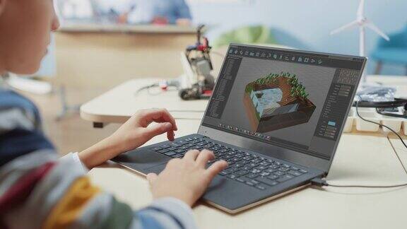 小学计算机科学课堂:一个孩子用笔记本电脑设计3D游戏在战略角色扮演电子游戏中构建关卡