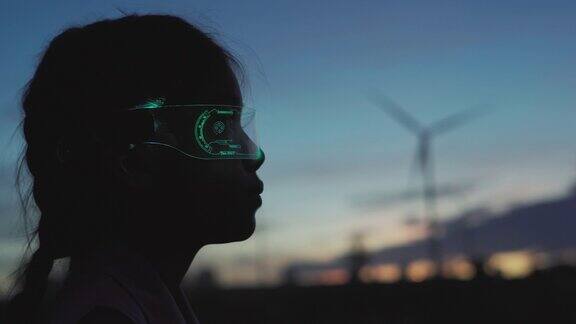 未来女孩戴着虚拟现实眼镜在风力涡轮机农场