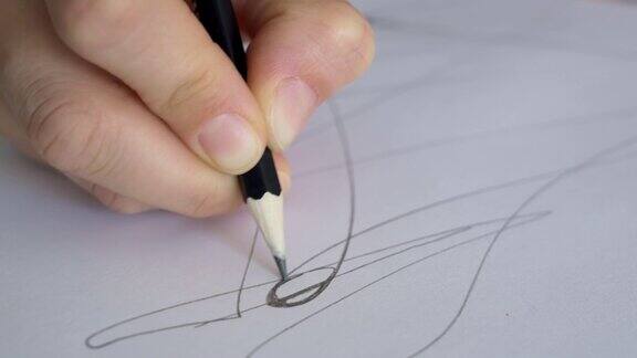 设计师用铅笔在纸上工作画家在纸上画素描在一张纸上用铅笔画线的特写镜头神经学和治疗