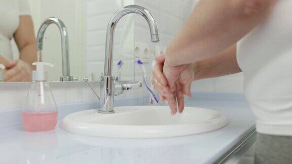 一个女人在水槽里洗手
