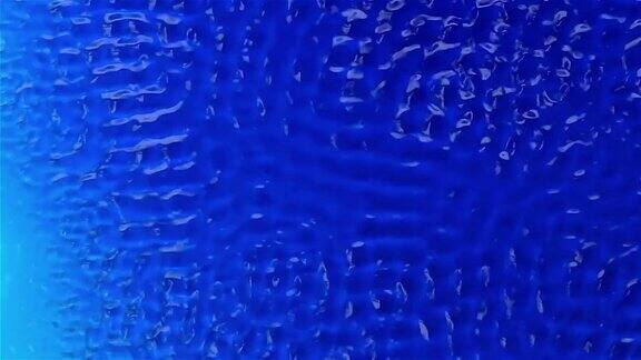 水在振动的作用下产生图形纹理蓝色背景慢动作
