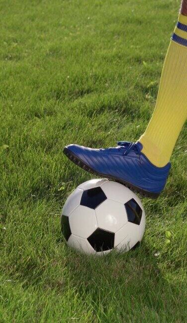 足球运动员的脚和球场草地上的球慢动作足球世界杯