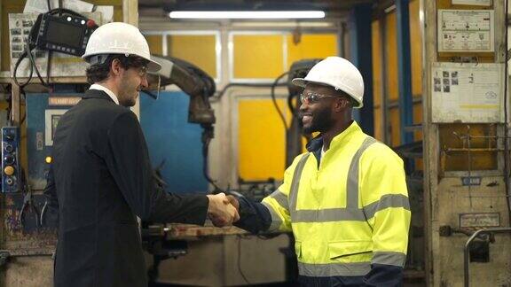 慢动作商人与黑人非洲工程师在自动化工厂握手