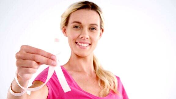 微笑的妇女展示乳腺癌意识丝带