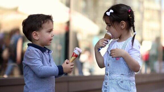 可爱的孩子们在购物中心前分享冰淇淋