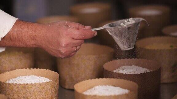 糕点师在传统的意大利潘妮朵上撒糖粉的慢镜头高质量的全高清镜头