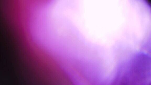 旋转抽象的紫罗兰散景神奇的光泄漏