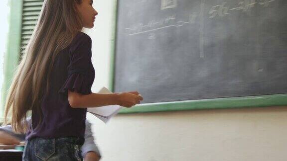 在课堂上微笑的拉丁女孩女学生在学校