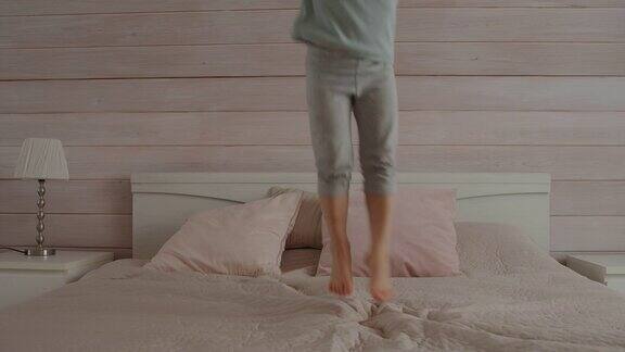 小女孩光着脚在床上跳享受快乐的时光慢动作
