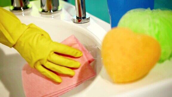手戴手套用抹布擦拭浴缸打扫浴室