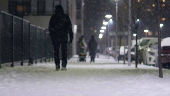 人们在冬天的城市街道在下雪慢动作