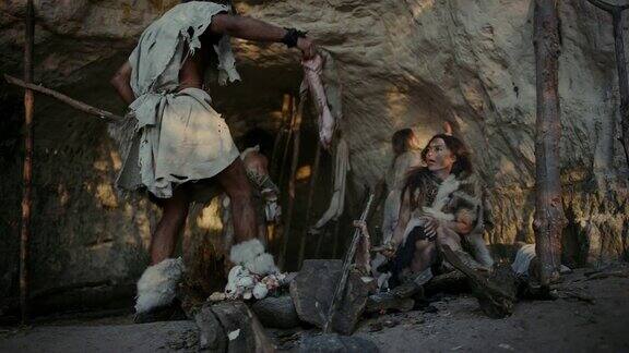 穿兽皮住在山洞里的采猎部落队长从狩猎中带来猎物女性在篝火上烹饪食物女孩在墙上画画创造艺术尼安德特人智人家族