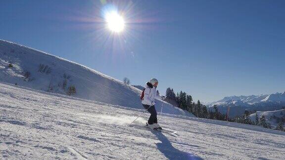 在阳光明媚的冬日里滑雪者在滑雪场上滑雪
