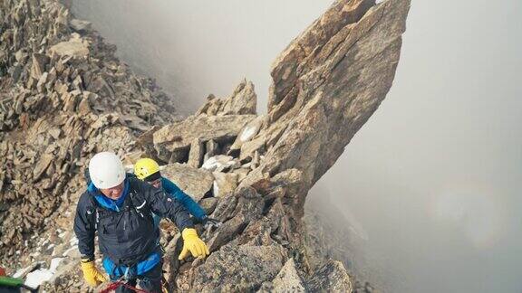专业的资深登山者正在攀登欧洲阿尔卑斯山的陡峭山峰使用绳子鸟瞰图