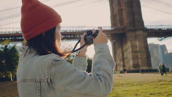亚洲女游客用数码相机拍摄河的全景
