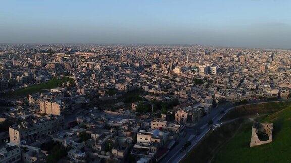 日落下无人机飞过阿勒颇城堡上空我们可以在4K的地平线上看到叙利亚城市