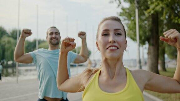 健康的运动夫妇在城市的户外散步做手臂伸展在积极健康的生活方式