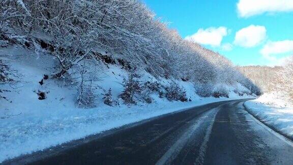 行驶在冬日的道路上经过雪山林间