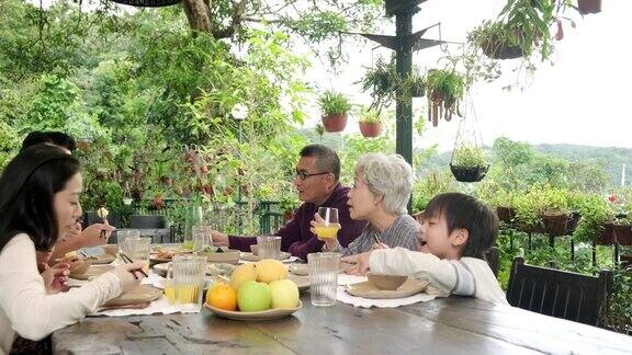 在户外吃午饭的中国家庭
