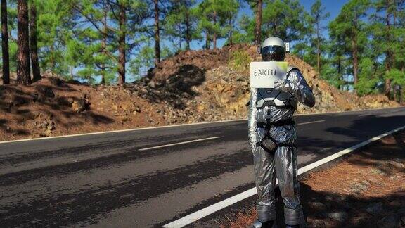 宇航员正在寻找返回地球的机会在山路上搭便车