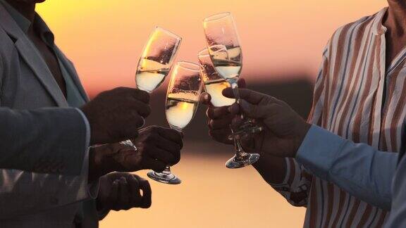生意人在日落时分用香槟干杯的特写