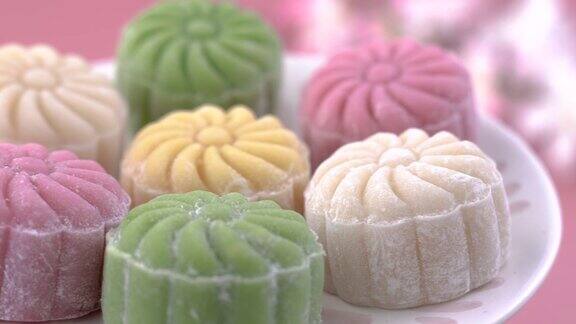 五颜六色的雪皮月饼传统美味的甜点中秋节在柔和的淡粉色背景