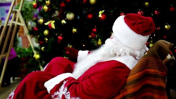 快乐的圣诞老人在摇椅上挥手欢迎