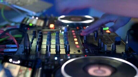 夜总会迪斯科派对Dj混音台的特写DJ手触摸按钮和滑块播放电子音乐高质量4k镜头