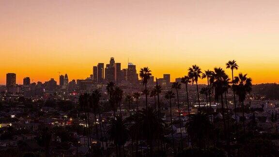 美丽的洛杉矶市中心和棕榈树白天到晚上日落时间