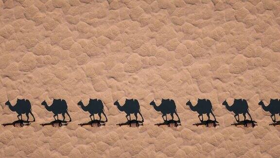 骆驼商队走过沙漠投下阴影俯视图