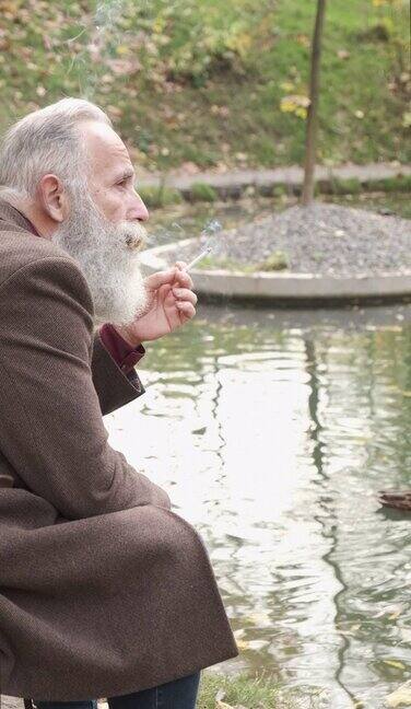 一个成年人在池塘边抽烟一个人垂直视频