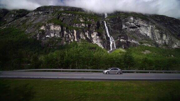 巨魔山瀑布和从火车窗口看到的汽车挪威劳马铁路观光列车