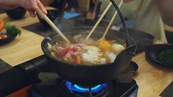 一家人在日本餐馆吃涮涮锅晚餐和家人一起吃涮锅饭