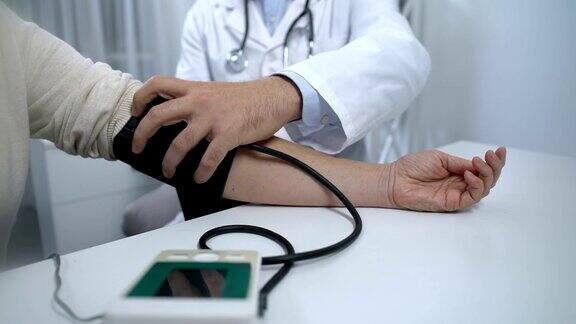 自信的医生为病人检查血压并给出建议健康