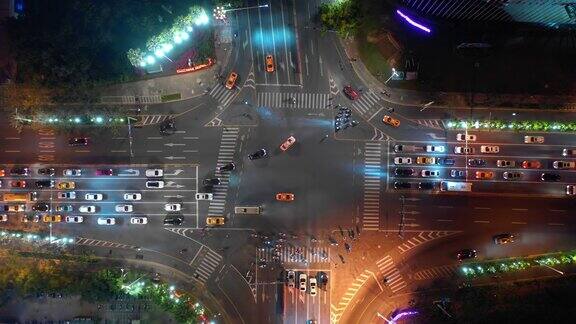夜晚照亮三亚市交通街道十字路口高空俯视图4k中国海南