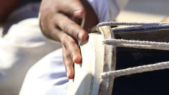 一个人在打邦戈鼓近距离近距离用手敲邦戈鼓鼓手动作节奏果阿阿拉波海滩印度