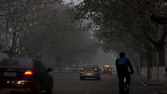清晨的街道上行人和车辆被雾霾笼罩