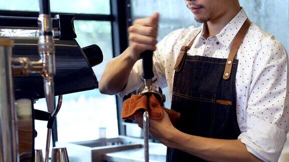 关闭亚洲咖啡师在工作期间在咖啡馆煮咖啡