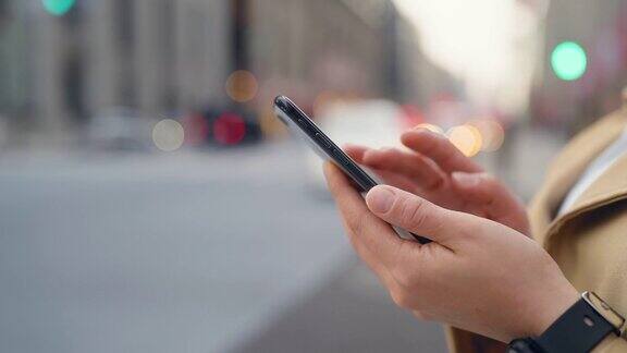 女商人的手在城市中使用智能手机的特写视频