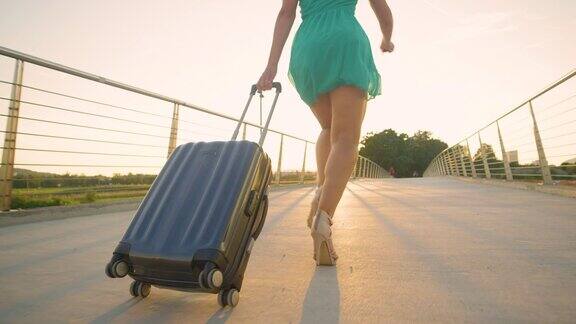 低角度:穿着高跟鞋的年轻女子带着她的行李跑着准时到达机场