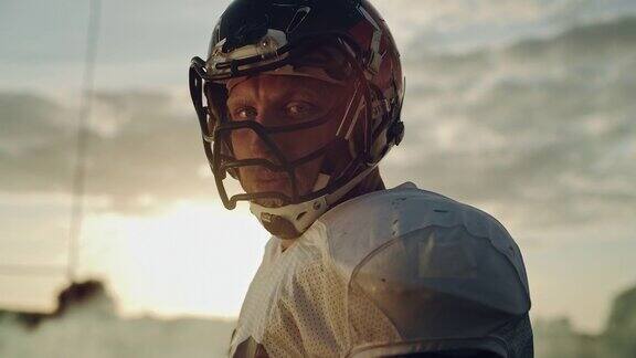 美国橄榄球冠军赛:职业球员的肖像戴着头盔转过身戏剧性地看着摄像机决心获胜的职业运