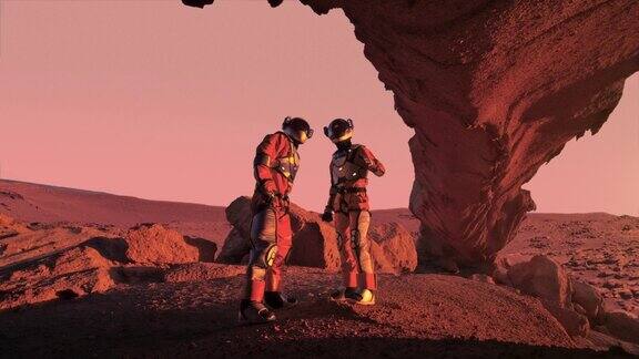 两名宇航员在红色星球火星上指着清澈的橙色天空