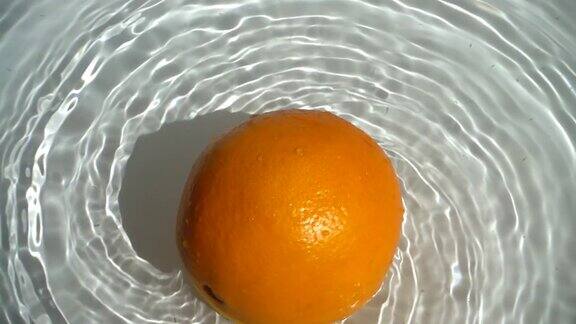 成熟的橘子在水中旋转缓慢的运动