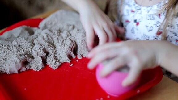 小女孩用沙子雕刻人物